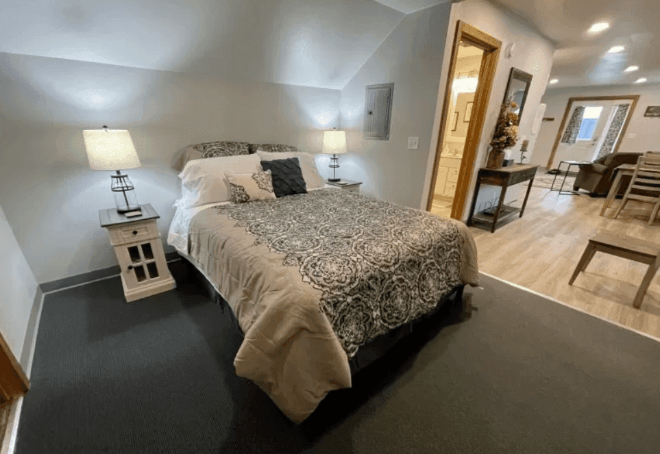 Apartment bedroom with patterned bedding and two bedside lamps