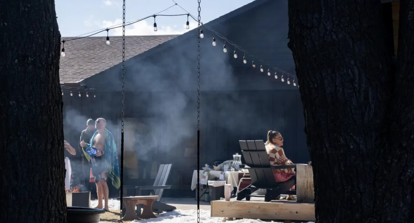 Steam rising at the sauna fest with string lights